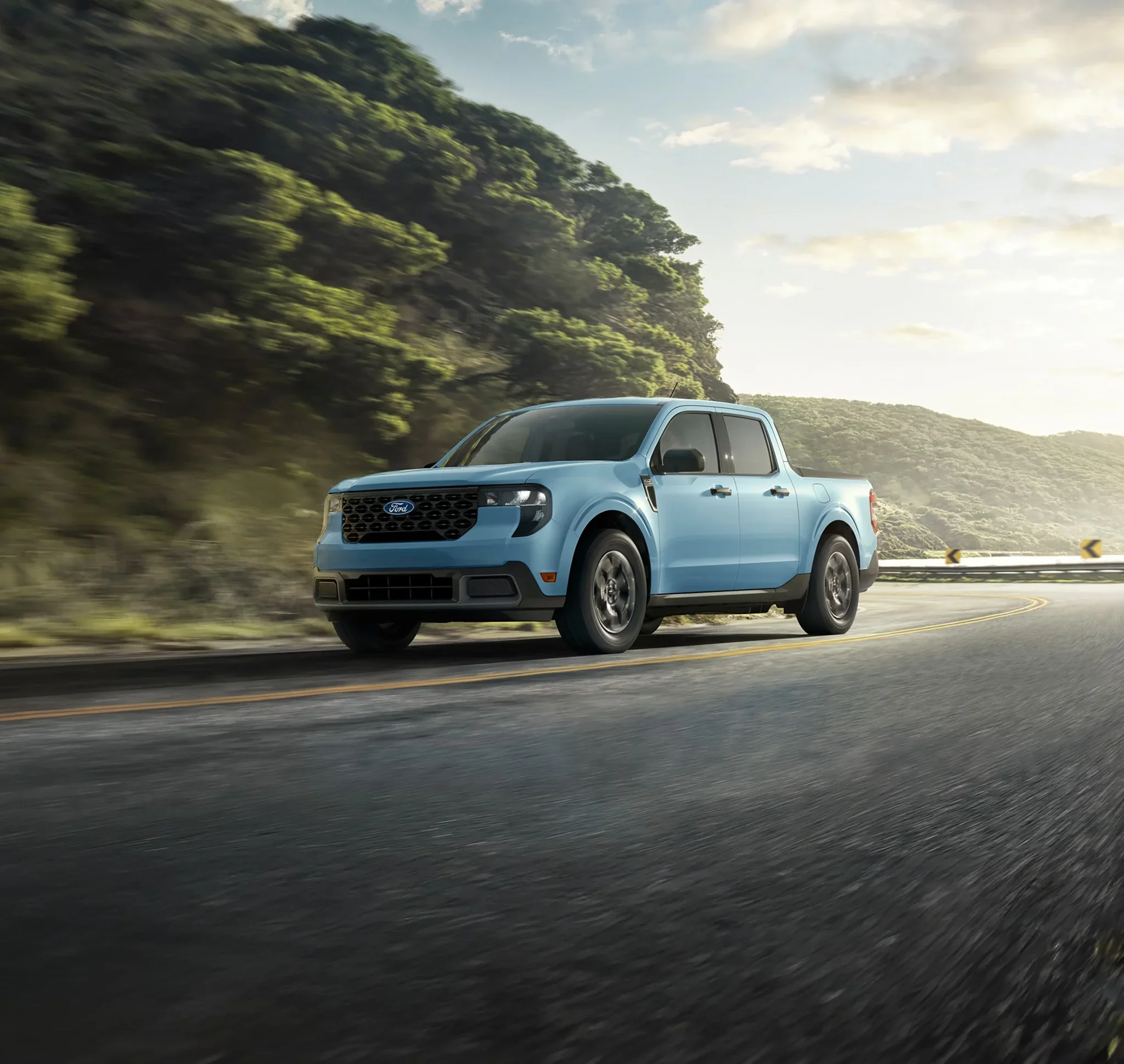 2026 Ford Maverick driving on a road, showing the standard hybrid powertrain in daily use